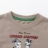 Close-up macro view of the collar and "Cholo Mickey" chest print, highlighting the pique knit texture and neat stitching of the cotton T-shirt.