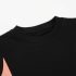 Close-up of black cotton t-shirt and peach side panel seam stitching - Co Kids Wear