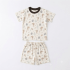 A flat lay studio photograph of a kids' short-sleeve t-shirt and matching shorts set, laid out on a clean, light-colored background. The set features an all-over cartoon print of koalas, kangaroos, and leafy sprigs, with a dark brown collar on the shirt.