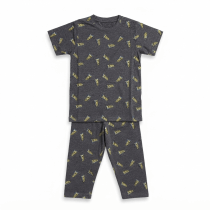A professional studio flat-lay photograph of a grey kids' short-sleeve t-shirt and matching pajama pants featuring an all-over X-Men themed graphic print, displayed on a clean white background.